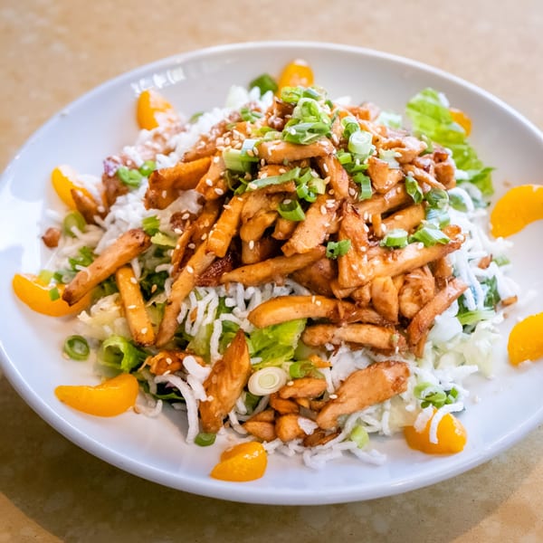 Pickles Deli's Asian chicken salad with mandarin oranges, crispy noodles, and green onions.